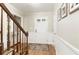 Bright foyer featuring hardwood floors, paneled walls, stairs, and a front door with glass panes at 3719 Northbrook Ct, Atlanta, GA 30340