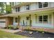 Inviting front porch with classic wood supports and steps leading to a manicured lawn and garden at 3719 Northbrook Ct, Atlanta, GA 30340