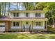Inviting two-story home with a classic front porch, lush lawn, and well-maintained landscaping at 3719 Northbrook Ct, Atlanta, GA 30340