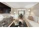 Bright living room featuring a plush sectional sofa, stylish decor, and an open view to the dining area at 3719 Northbrook Ct, Atlanta, GA 30340