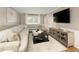 Cozy living room features a plush sectional sofa, stylish decor, and a mounted television at 3719 Northbrook Ct, Atlanta, GA 30340