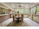 Relaxing screened-in porch with a ceiling fan, wood floors, and table for outdoor dining at 3719 Northbrook Ct, Atlanta, GA 30340