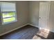 A comfortable bedroom features hard surface floors, neutral colored walls, and sun-filled window at 633 Tom Read Dr, Marietta, GA 30062