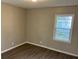 This bedroom features a neutral wall paint color and new hard surface flooring, alongside a bright window for natural light at 633 Tom Read Dr, Marietta, GA 30062