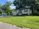 Cozy single-story home with a well-manicured lawn and lush trees in the front yard at 633 Tom Read Dr, Marietta, GA 30062