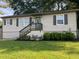 Charming single-story home featuring a well-maintained lawn, complemented by verdant greenery and a welcoming front entrance at 633 Tom Read Dr, Marietta, GA 30062