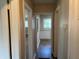 Bright hallway featuring wood floors, neutral paint, and views into other rooms at 633 Tom Read Dr, Marietta, GA 30062
