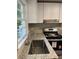 This kitchen features a stainless steel sink and modern appliances at 633 Tom Read Dr, Marietta, GA 30062