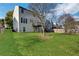 Large, grassy backyard with mature trees and a privacy fence, perfect for outdoor enjoyment at 3704 Ramsey Sw Cir, Atlanta, GA 30331