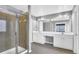 Large bathroom featuring double sinks, granite countertop, a glass shower, and neutral tiling for a bright, clean look at 3704 Ramsey Sw Cir, Atlanta, GA 30331