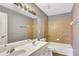 Bathroom with double sink vanity and a bathtub with tiled walls at 3704 Ramsey Sw Cir, Atlanta, GA 30331