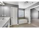Bathroom featuring white vanity, built-in tub, and doorway leading to a bedroom at 3704 Ramsey Sw Cir, Atlanta, GA 30331