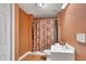 Cozy bathroom featuring a shower-tub combination, vanity sink, and warm color scheme at 3704 Ramsey Sw Cir, Atlanta, GA 30331