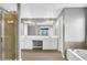 Bright bathroom features a double vanity, framed mirror, separate shower, and soaking tub at 3704 Ramsey Sw Cir, Atlanta, GA 30331