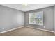 Bedroom with neutral carpet, gray walls, and a window offering natural light at 3704 Ramsey Sw Cir, Atlanta, GA 30331