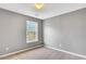Bedroom with neutral carpet, gray walls, and a window offering natural light at 3704 Ramsey Sw Cir, Atlanta, GA 30331