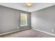 Bedroom with neutral carpet, gray walls, and a window offering natural light at 3704 Ramsey Sw Cir, Atlanta, GA 30331