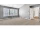 Spacious bedroom features plush carpet, large windows, and hallway access at 3704 Ramsey Sw Cir, Atlanta, GA 30331