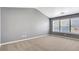 Bright and spacious bedroom featuring plush carpet, vaulted ceiling, and large windows at 3704 Ramsey Sw Cir, Atlanta, GA 30331