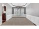 The dining room is bright with a tray ceiling, a chandelier, and wainscoting at 3704 Ramsey Sw Cir, Atlanta, GA 30331