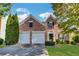 Charming two-story brick home featuring a well-manicured lawn, two-car garage, and a welcoming entrance, perfect for suburban living at 3704 Ramsey Sw Cir, Atlanta, GA 30331