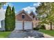 Charming two-story brick home featuring a well-manicured lawn, two-car garage, and a welcoming entrance, perfect for suburban living at 3704 Ramsey Sw Cir, Atlanta, GA 30331