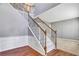 Bright foyer featuring hardwood floors, a staircase with decorative iron railings, and neutral paint create a welcoming atmosphere at 3704 Ramsey Sw Cir, Atlanta, GA 30331