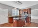 The kitchen features a central island, stainless appliances and granite countertops at 3704 Ramsey Sw Cir, Atlanta, GA 30331