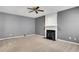 Bright living room showcases fireplace with mantle and plush carpet at 3704 Ramsey Sw Cir, Atlanta, GA 30331