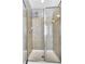 Walk-in shower featuring glass doors, tiled surround, and overhead shower head at 3704 Ramsey Sw Cir, Atlanta, GA 30331