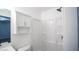 Bright bathroom featuring modern fixtures, cabinet, and walk-in shower at 4443 Toonigh Nw Rd, Acworth, GA 30101