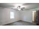 Bright bedroom with neutral carpet, ceiling fan, and en suite bathroom access at 4443 Toonigh Nw Rd, Acworth, GA 30101