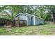 View of the exterior back of this light blue house featuring a wooden deck and fenced in backyard at 4443 Toonigh Nw Rd, Acworth, GA 30101