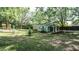 Home featuring a covered front porch, fenced yard, landscaping, and mature trees at 4443 Toonigh Nw Rd, Acworth, GA 30101