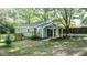 Home featuring a covered front porch, fenced yard, landscaping, and mature trees at 4443 Toonigh Nw Rd, Acworth, GA 30101