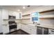 Updated kitchen featuring granite countertops, stainless steel appliances, and white cabinets at 4443 Toonigh Nw Rd, Acworth, GA 30101