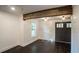 Bright living room with hardwood floors, wooden beam, and white shiplap accent wall at 4443 Toonigh Nw Rd, Acworth, GA 30101