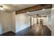 Open-concept living room featuring wood floors, shiplap, and an exposed beam at 4443 Toonigh Nw Rd, Acworth, GA 30101