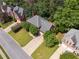 An aerial view of the beautiful brick home featuring a well-manicured lawn, mature trees and an ample driveway at 5013 Kendall Nw Sta, Acworth, GA 30102