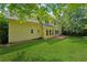 Expansive backyard featuring healthy green grass, shade trees, and a brick patio space at 5013 Kendall Nw Sta, Acworth, GA 30102