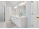 Bright bathroom with double vanity, built in cabinets, and a large decorative mirror at 5013 Kendall Nw Sta, Acworth, GA 30102