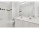 Bright white bathroom with double sink vanity and tiled shower/tub with decorative accents at 5013 Kendall Nw Sta, Acworth, GA 30102