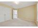 Sunlit carpeted bedroom with double closet and view into hallway and stairway at 5013 Kendall Nw Sta, Acworth, GA 30102