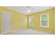 Yellow bedroom with two windows providing natural light and a ceiling fan at 5013 Kendall Nw Sta, Acworth, GA 30102