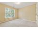 Carpeted bedroom with large window showing leafy view, painted in light yellow at 5013 Kendall Nw Sta, Acworth, GA 30102