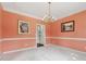 Dining room featuring a decorative chandelier and salmon colored walls at 5013 Kendall Nw Sta, Acworth, GA 30102