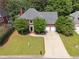 Traditional two-story brick home with mature landscaping, two car garage, and long driveway at 5013 Kendall Nw Sta, Acworth, GA 30102