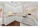 Kitchen boasts white cabinets, granite countertops, and stainless-steel sink at 5013 Kendall Nw Sta, Acworth, GA 30102