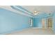 Large main bedroom with blue walls, tray ceiling, large windows and view of the attached bathroom at 5013 Kendall Nw Sta, Acworth, GA 30102