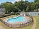 An aerial view of a community pool offering a fenced-in area, plenty of lounge chairs, tables and a nearby tennis court at 5013 Kendall Nw Sta, Acworth, GA 30102